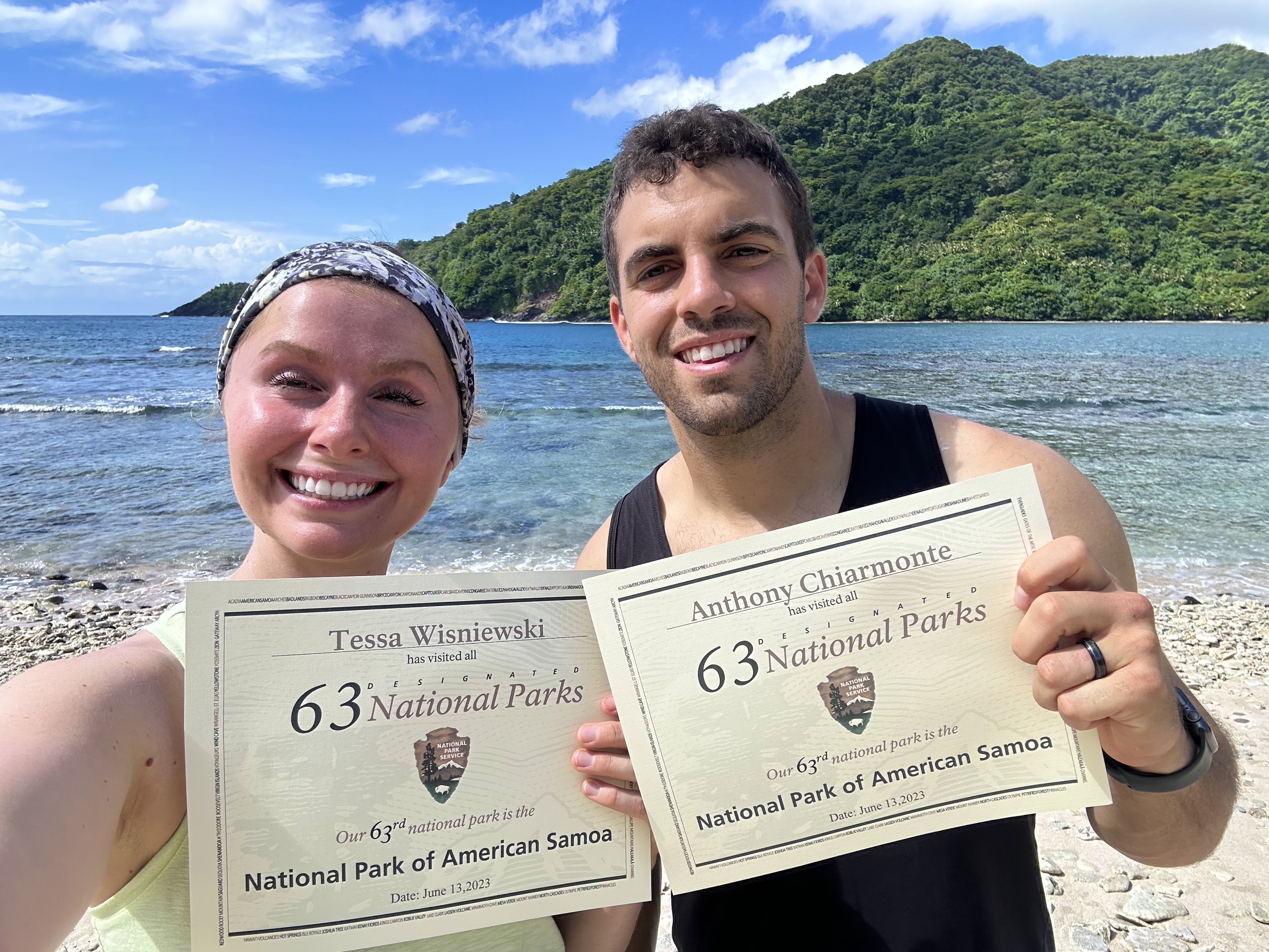 Tessa Wisniewski‘17, ‘19 and her husband holding up certificates that say 63 National Parks
