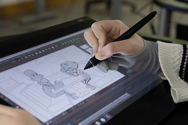 Animation student drawing on tablet