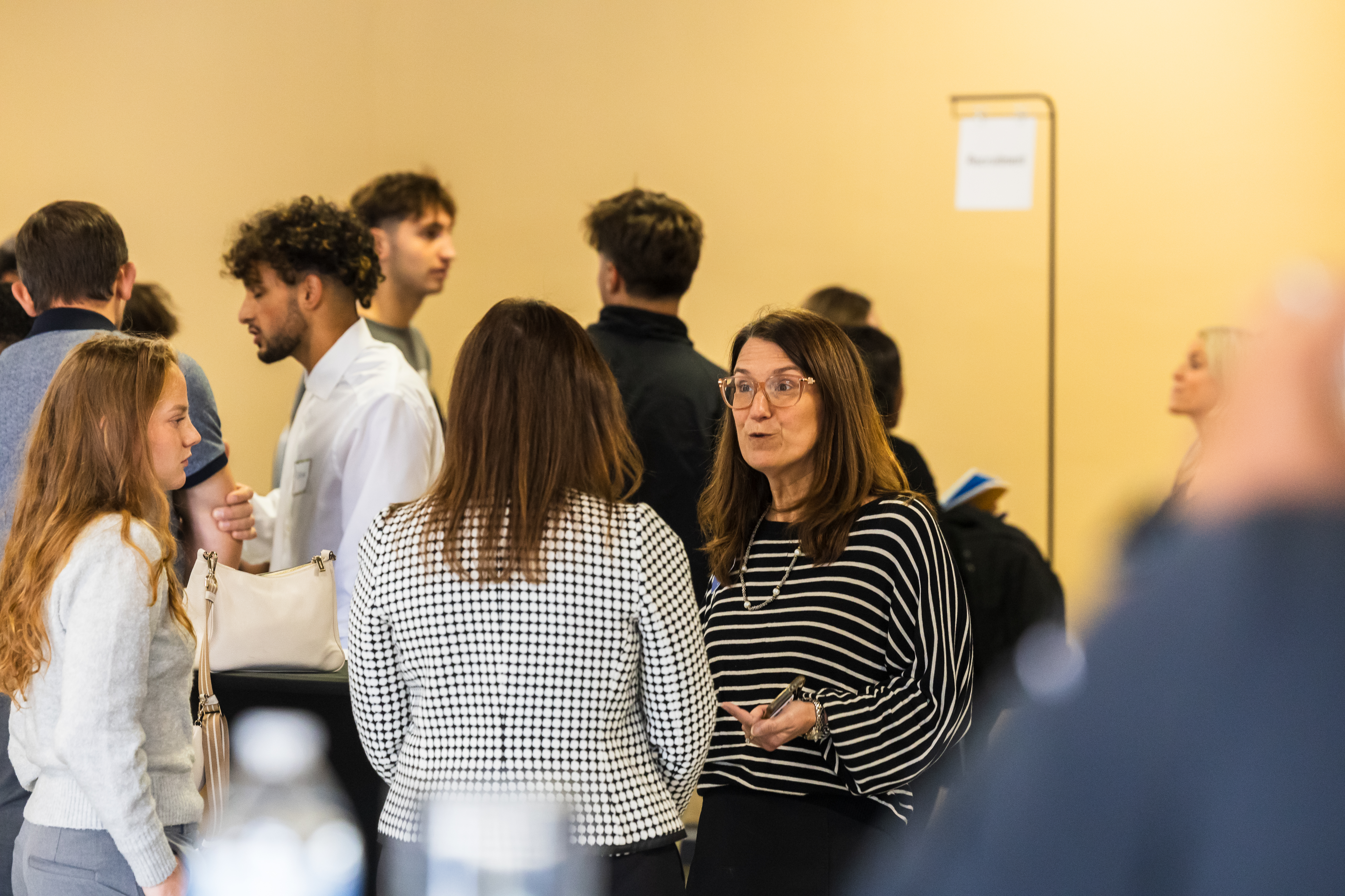 Female students talking with female faculty member