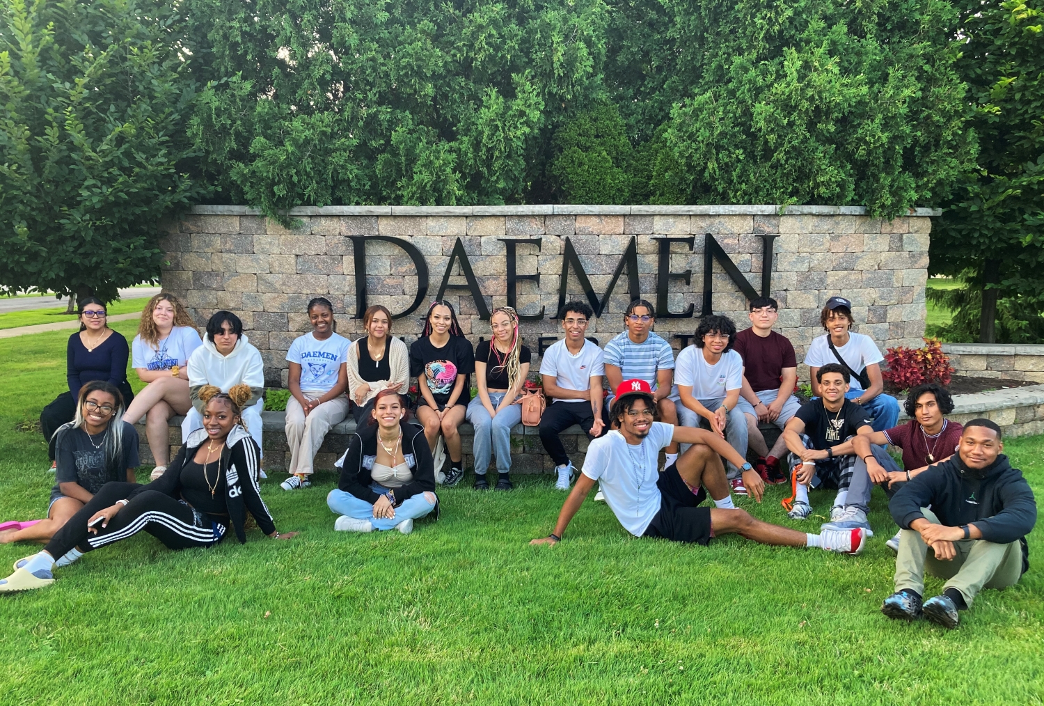 TRI Scholars posing in front of the Daemen sign on Main Street