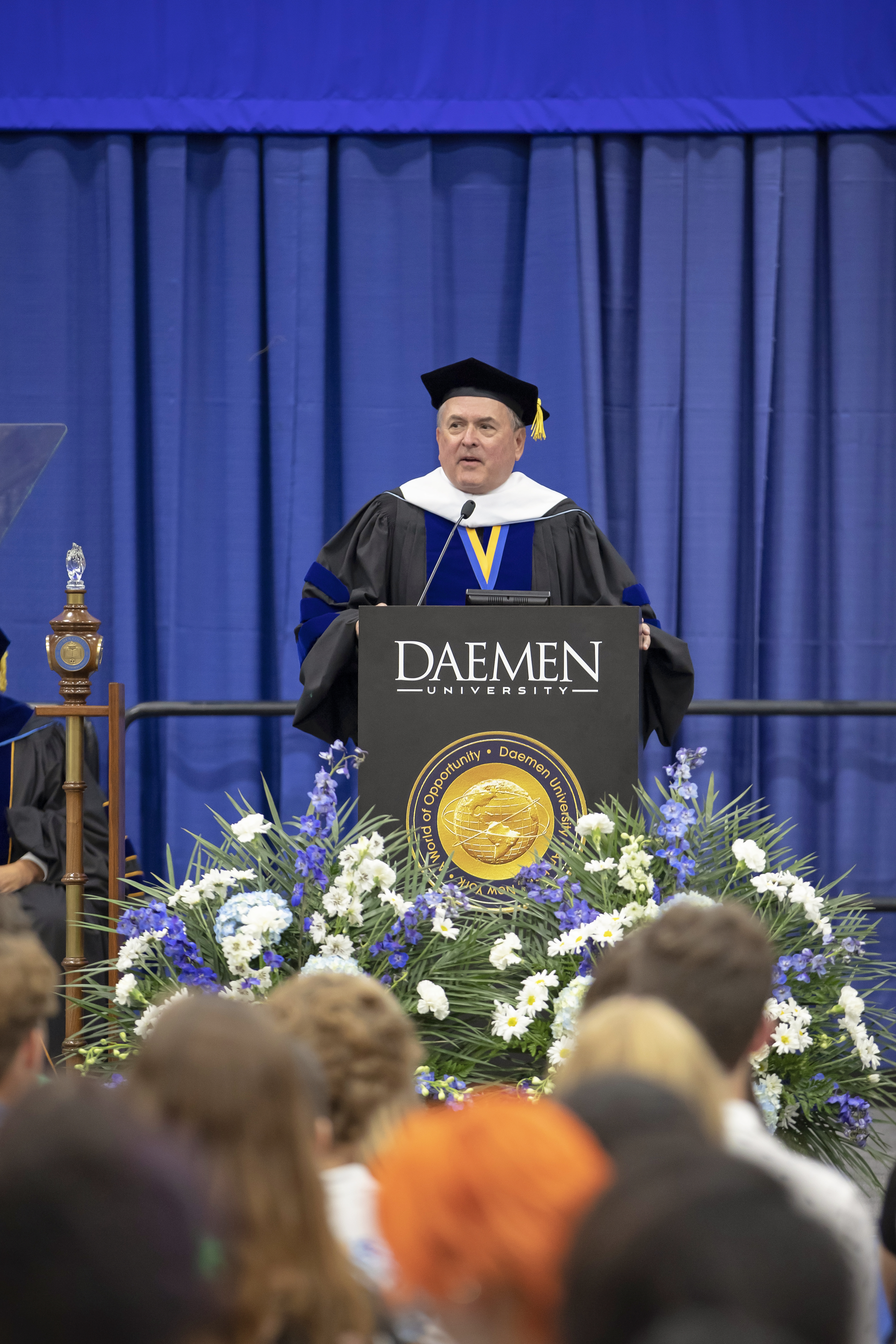 John Yurtchuk speaking from a podium at commencement