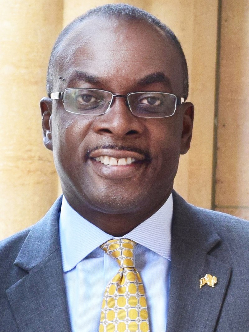 Byron Brown smiling, wearing a suit and yellow tie