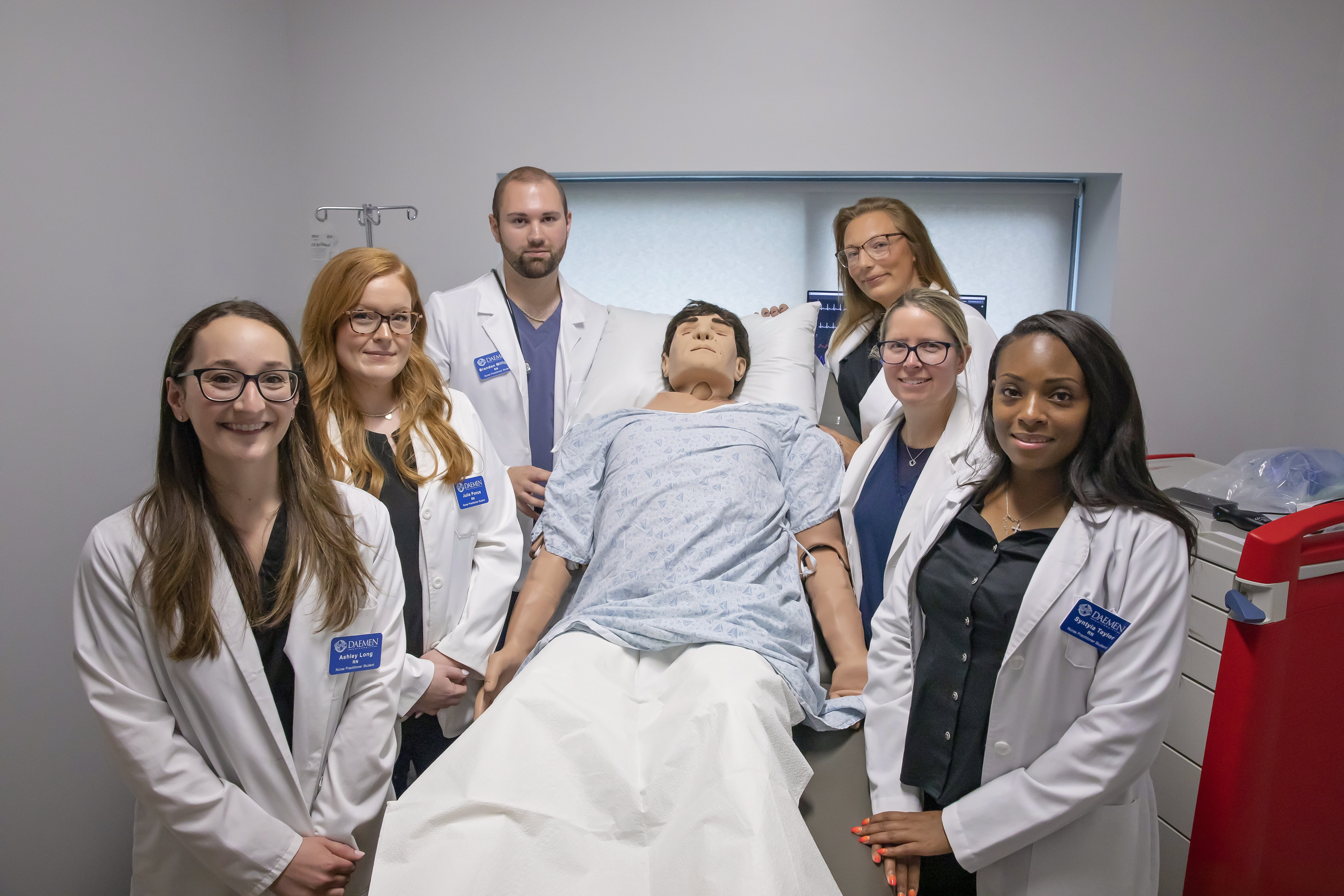 Faculty and students posing with a new high-fidelity manikin in the CILS