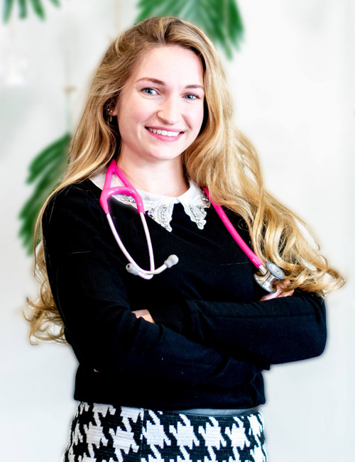 Angeleah Lograsso with pink stethoscope with arms folded in front of a white background