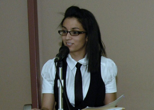 Female student speaking at a podium