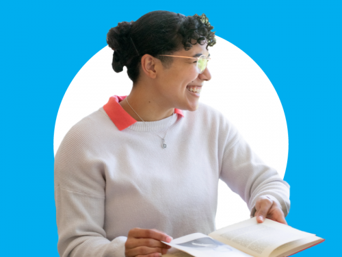 Female student sitting with a book in a white circle with a light blue background