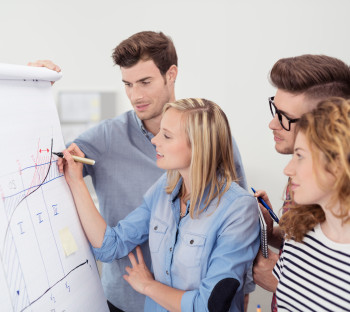 People working on a dry erase board